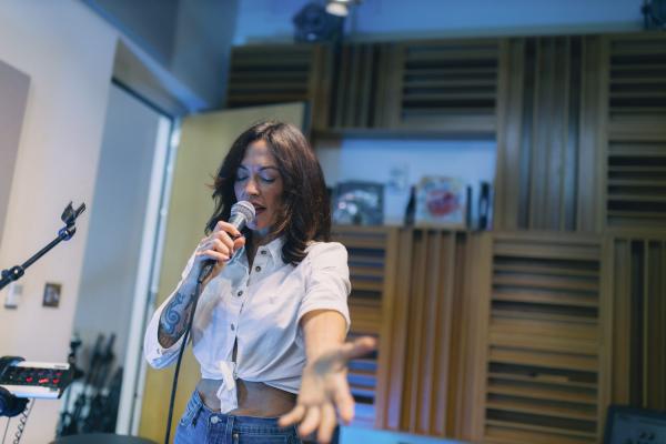 Amanda Shires singing holding hand out